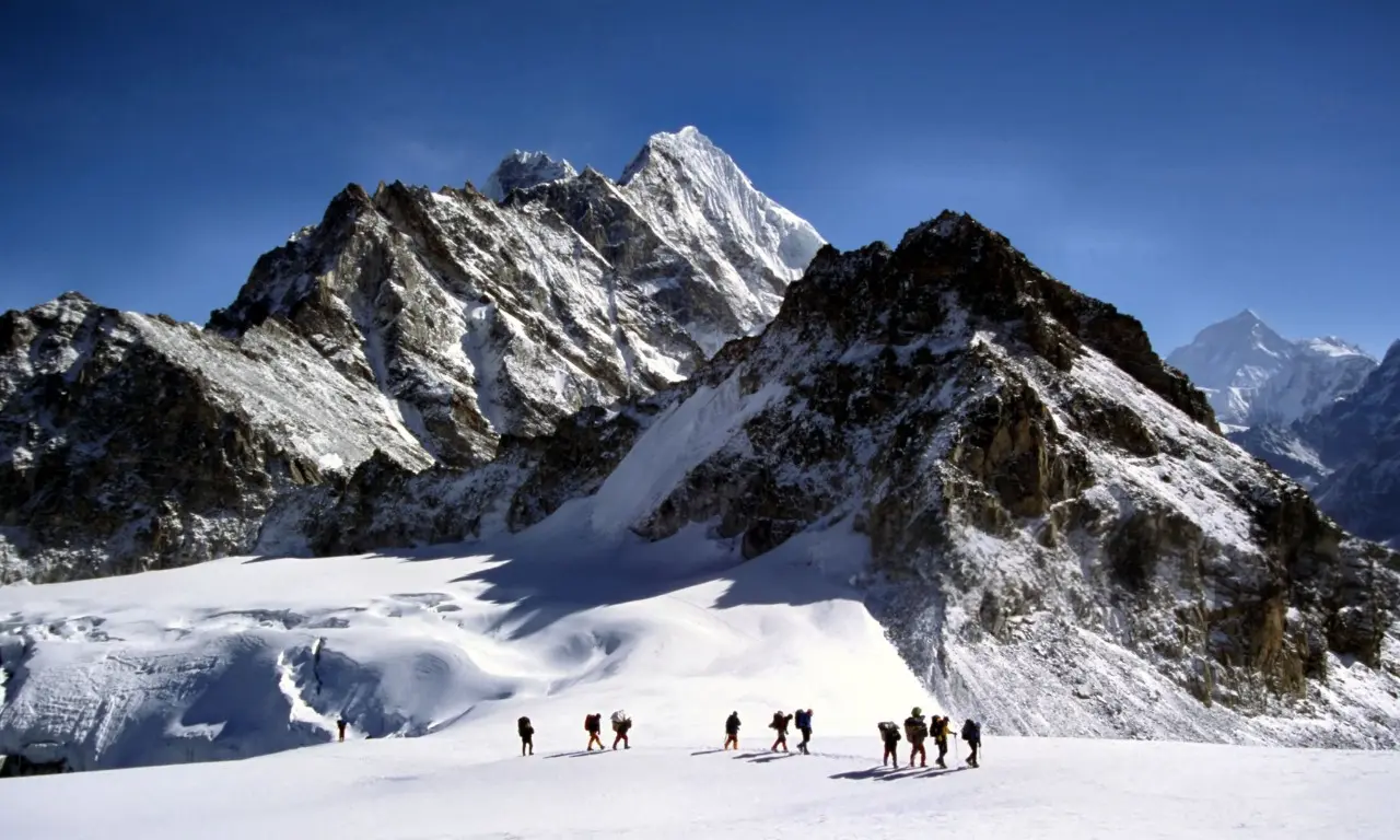Climbers on Mera Peak summit with Himalayan views.