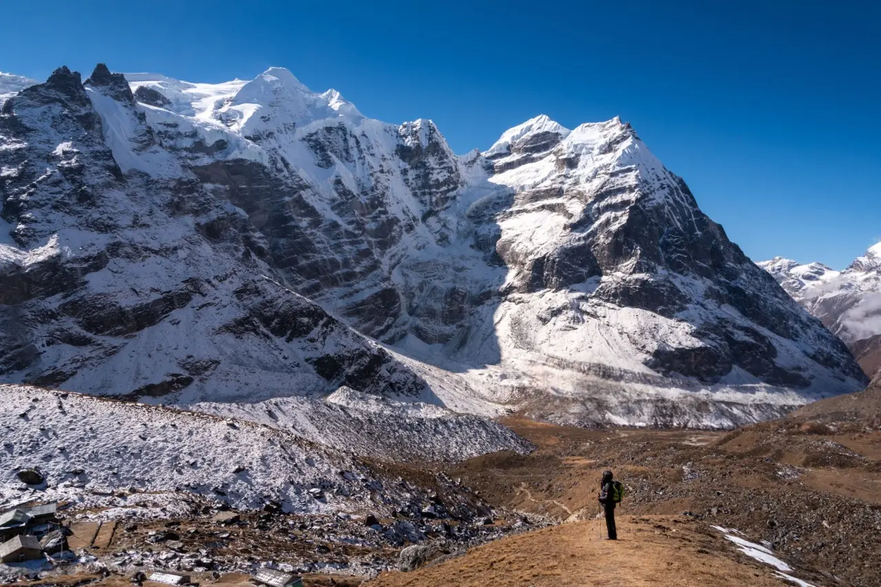 Climber on Mera Peak with Himalayan landscapes.