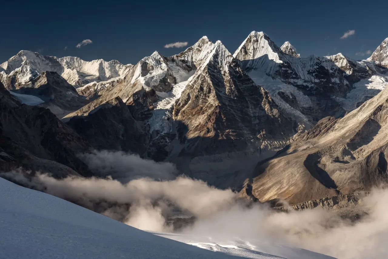 Mera Peak summit with snow and clouds.