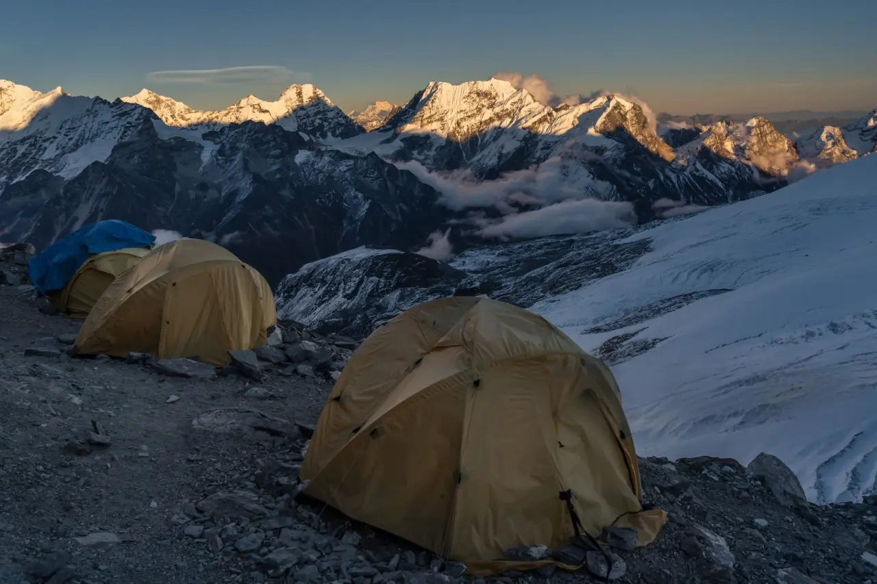 Sunrise over Mera Peak with Himalayan peaks.