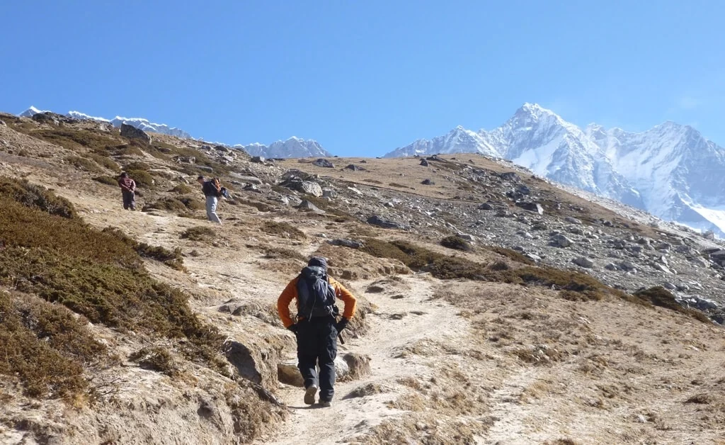 Small group trekking on Short Everest Trek – hikers navigating Himalayan trails with stunning mountain views.