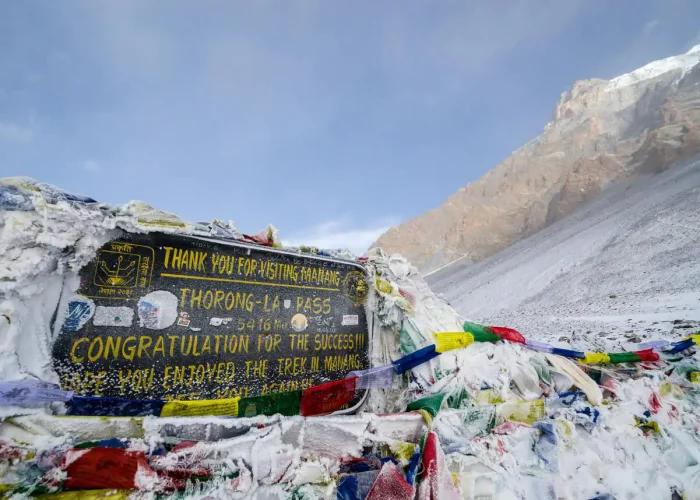 Thorong La Pass board at 5,416 meters on Annapurna Circuit Trek with Tilicho Lake, Nepal