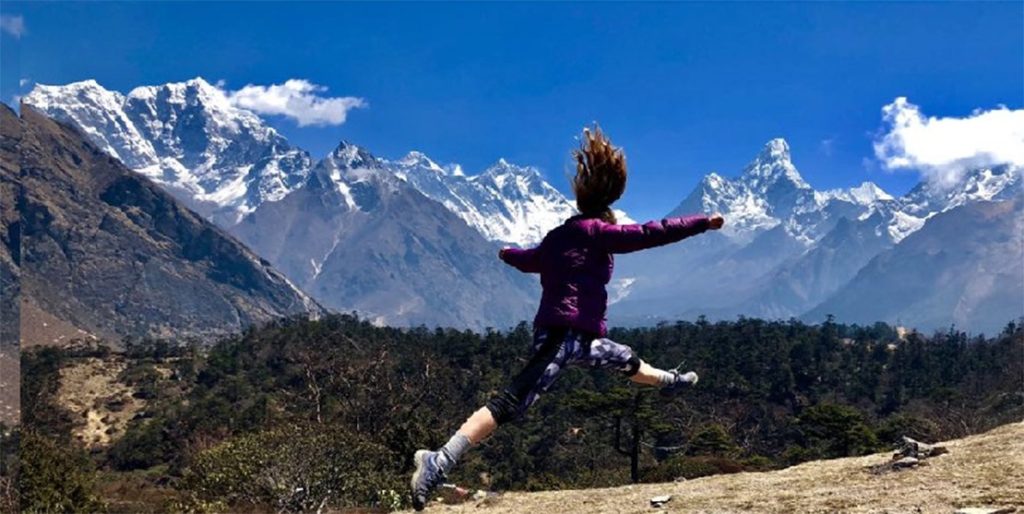 Girl practicing yoga in serene mountain setting at Nepal yoga retreat destinations