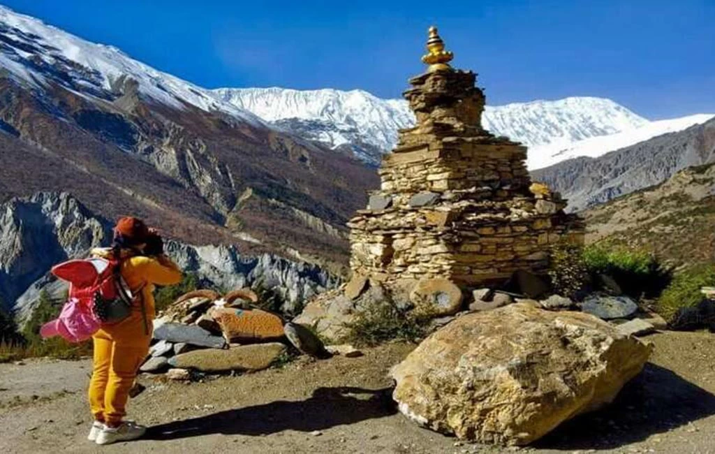 Lady paying respects at a Himalayan shrine on the Annapurna Circuit Trek in Nepal