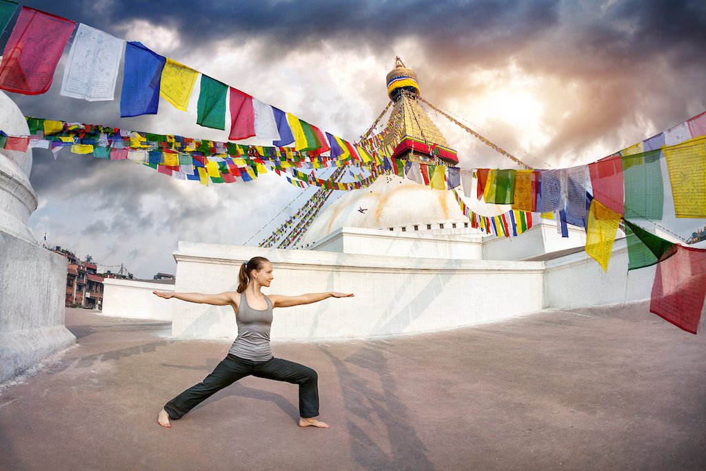 budget yoga retreat Girl practicing yoga near Boudhanath Stupa at affordable yoga retreats in Nepal