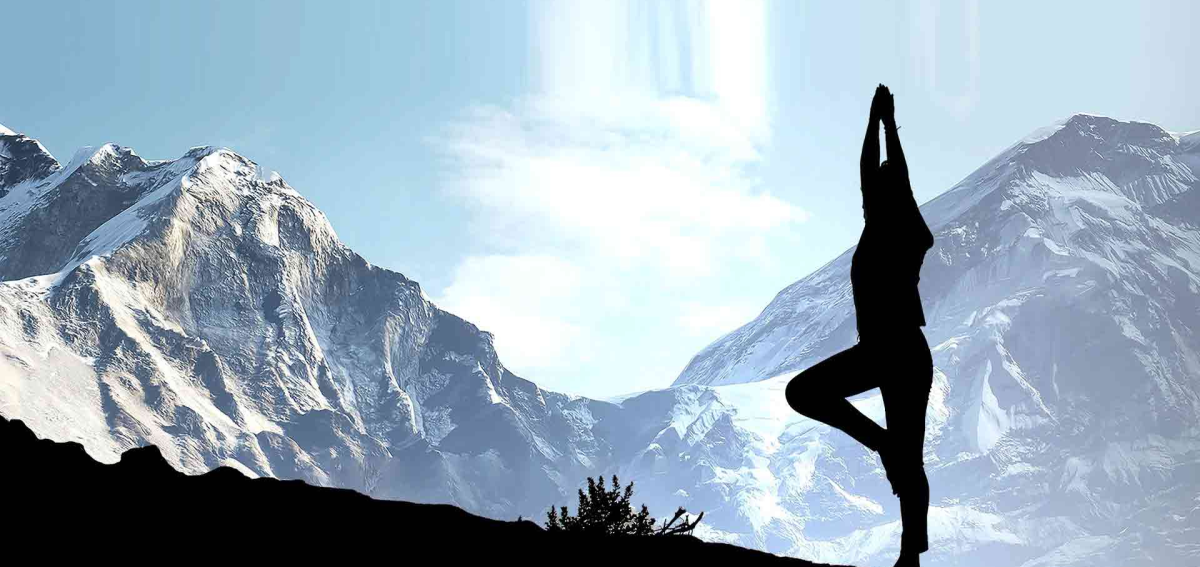 Person practicing yoga with Himalayan mountain backdrop at Nepal yoga retreat destinations
