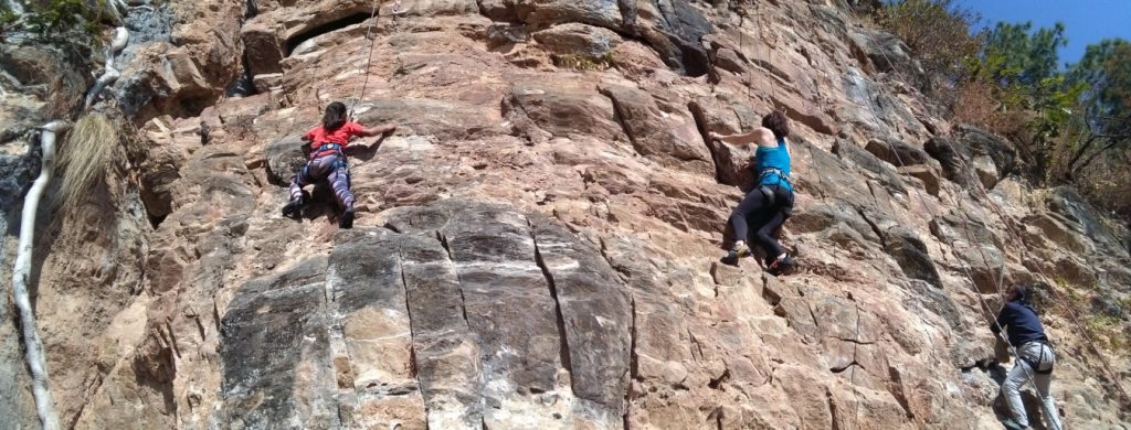 Tourists rock climbing in Nepal’s Himalayas during adventures in Nepal.
