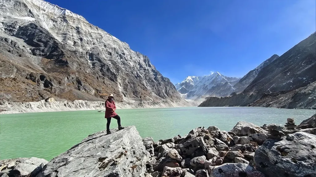 Tsho Rolpa glacial lake with trekker enjoying the view in Rolwaling Valley