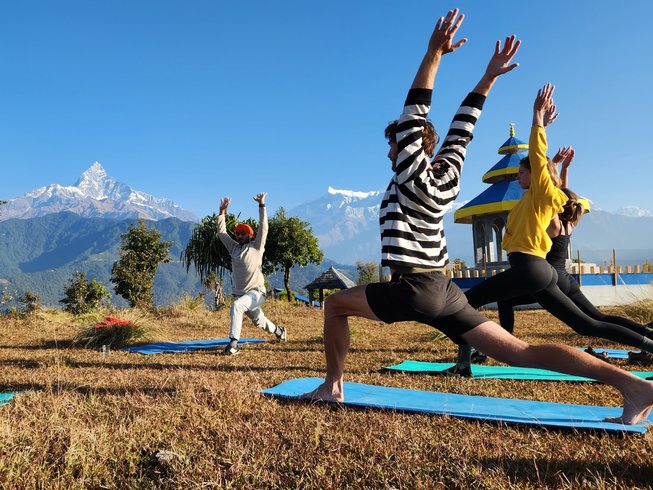 Group of tourists practicing yoga outdoors in Nepal during a yoga retreat experience