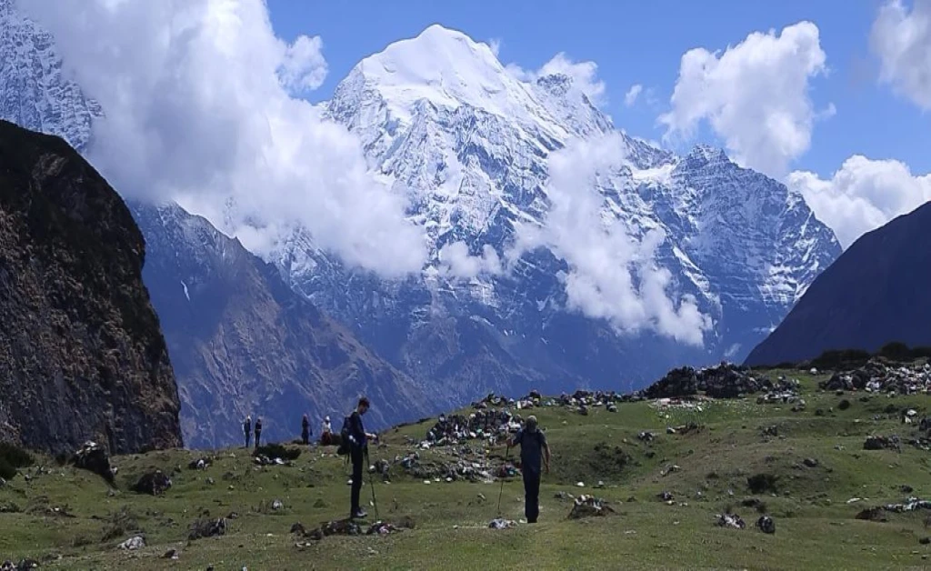 Trekkers walking along the Manaslu Circuit trekking trail while exploring the Manaslu Circuit Trek Cost and remote Himalayan landscapes