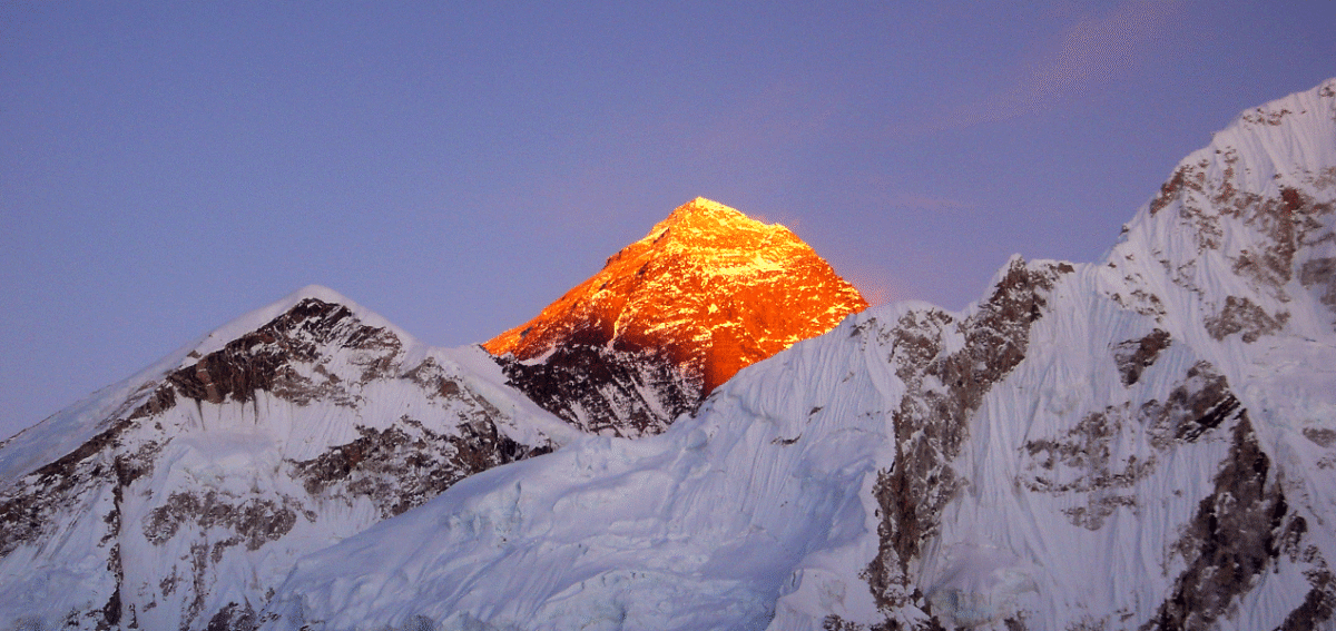 Sunset over Mount Everest with golden Himalayan peaks, showcasing beauty across EBC Spring vs Autumn trekking seasons