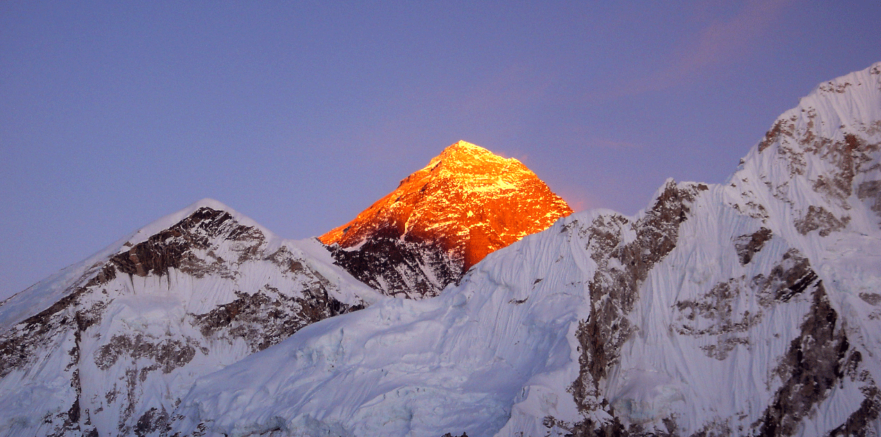 EBC Trek Sunset over Mount Everest with golden Himalayan peaks, showcasing beauty across EBC Spring vs Autumn trekking seasons