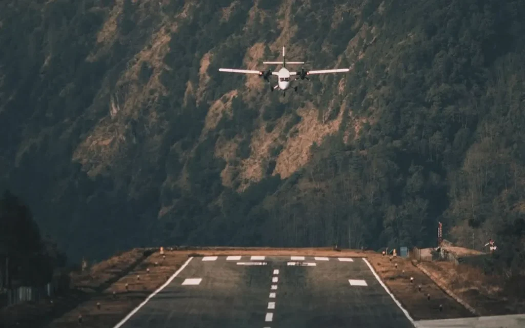 Airplane making a thrilling landing at Lukla Airport, the gateway to Everest Base Camp, surrounded by towering Himalayan peaks.