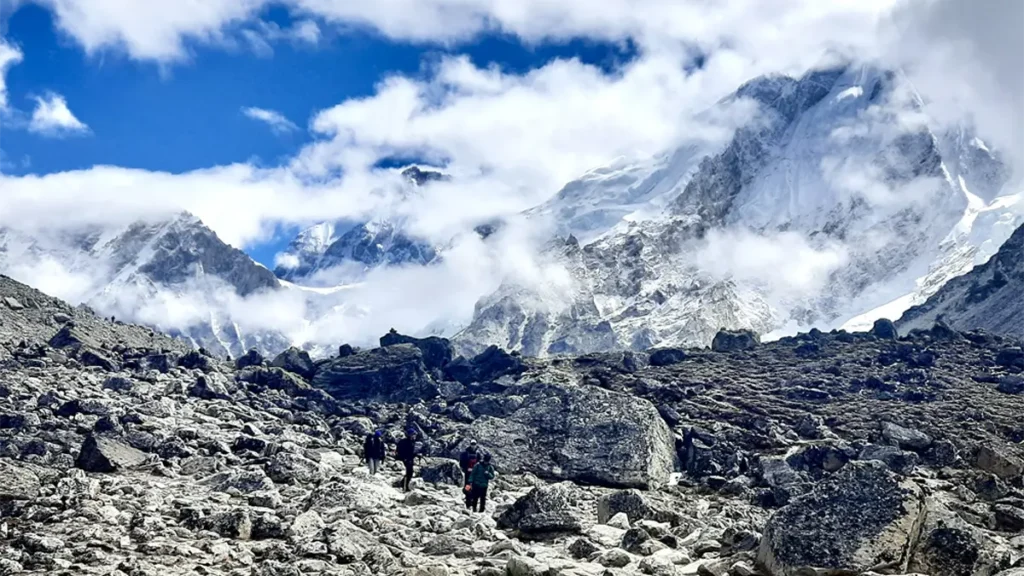 Everest Base Camp trek in spring with blooming rhododendrons and mountain views, showcasing EBC Spring vs Autumn trekking season comparison