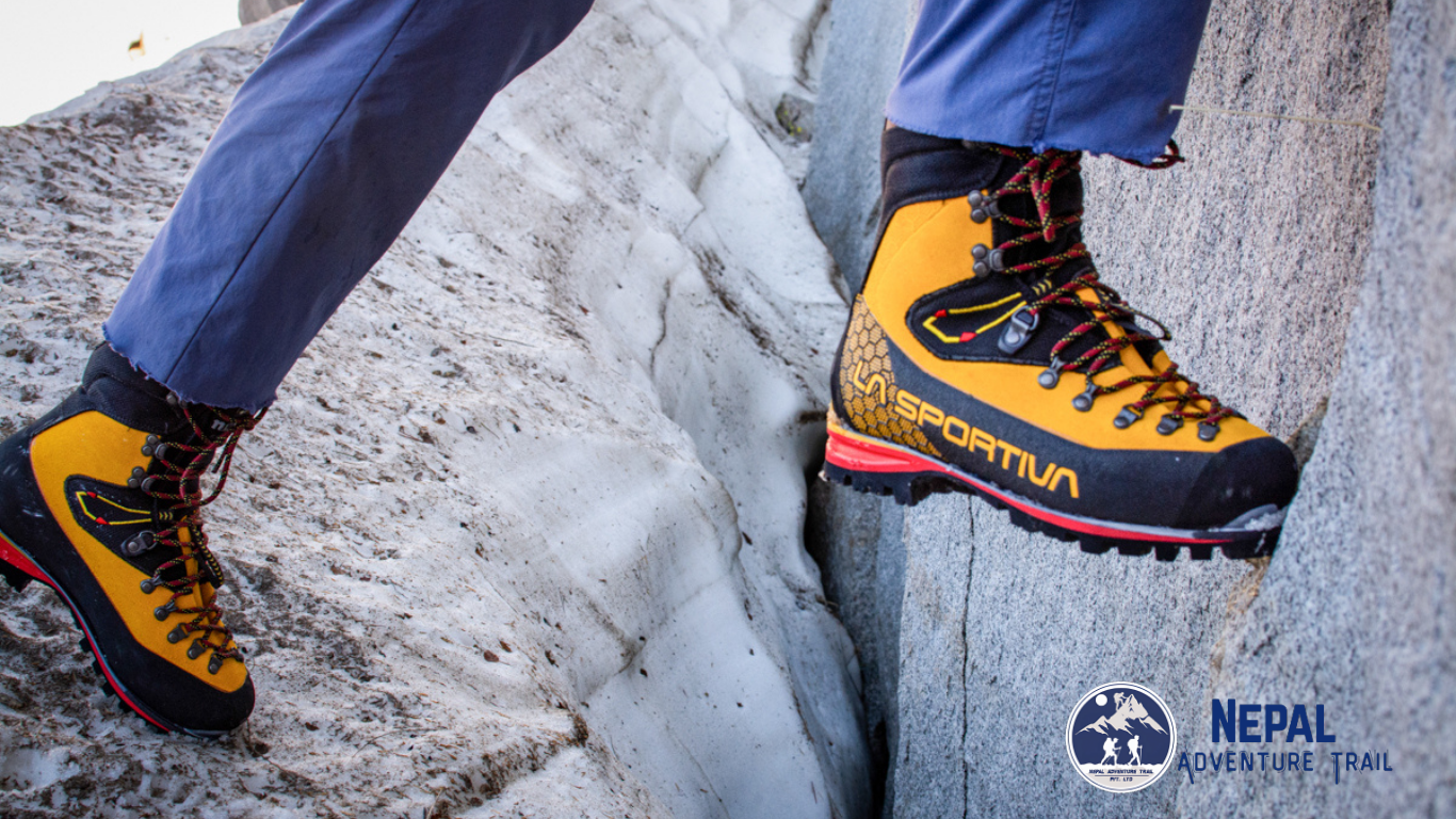 La Sportiva Nepal Evo GTX Trekker walking on Himalayan trail wearing La Sportiva Nepal Evo GTX mountaineering boots during high altitude trekking in Nepal with rocky terrain and alpine conditions
