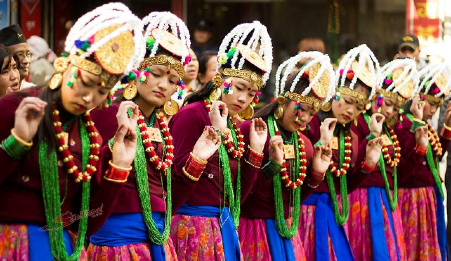 Young women dressed in traditional attire celebrating the Losar festival with bright smiles in Kathmandu.