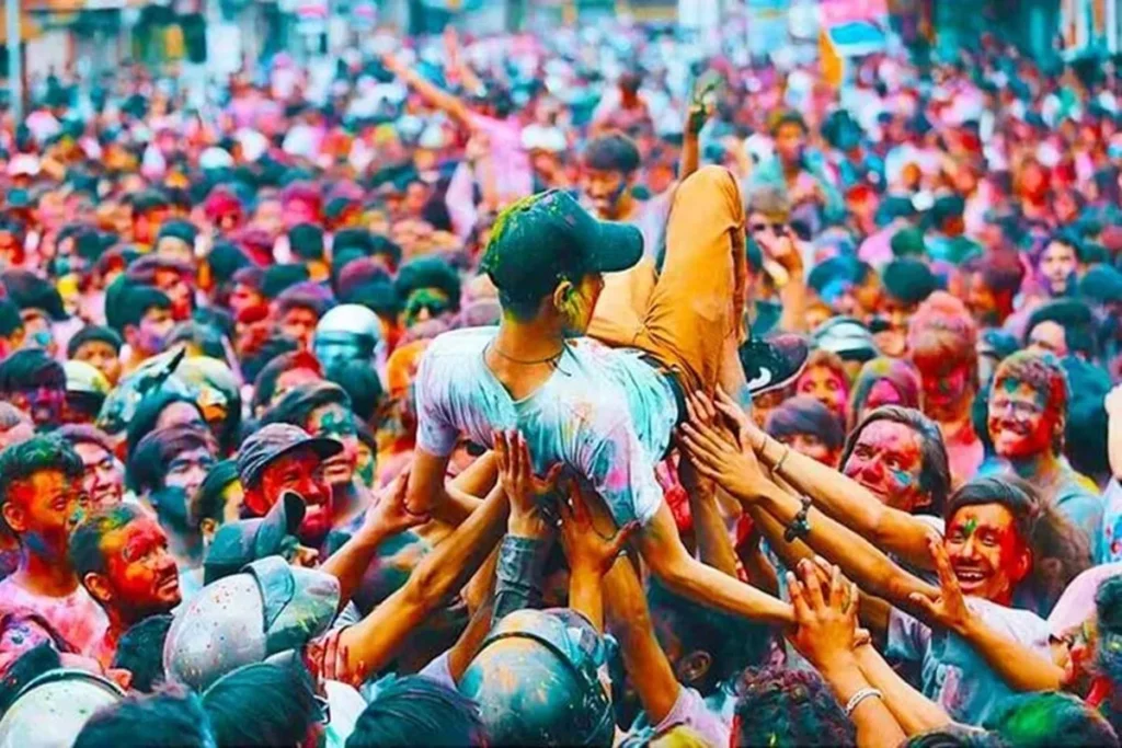 Travelers and locals playing with colored powder during the Holi festival in Nepal.