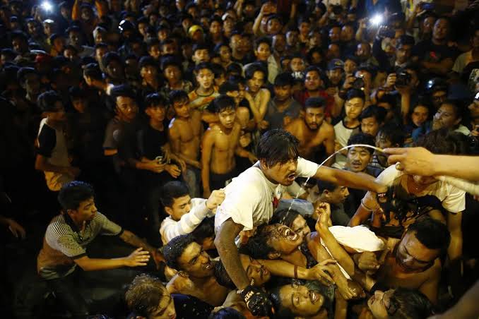 Crowds of people gathered at the Swet Bhairav mask to receive chhyang during the Indra Jatra festival in Kathmandu