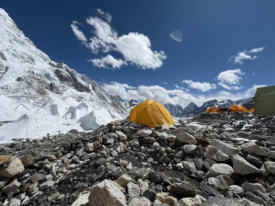 A small tent pitched near a mountain trail during the cheapest trek in Nepal.