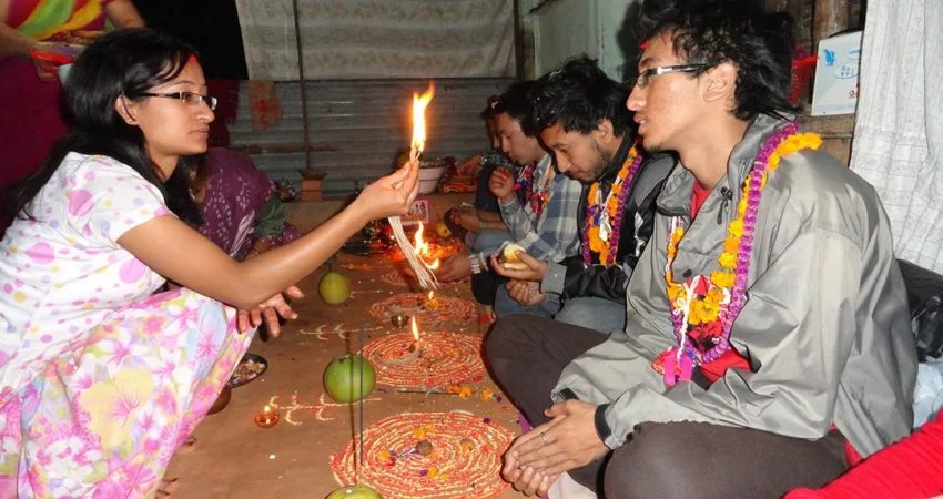 A sister applying a colorful tika on her brother's forehead during the Bhaitika ceremony at the Tihar festival in Nepal.