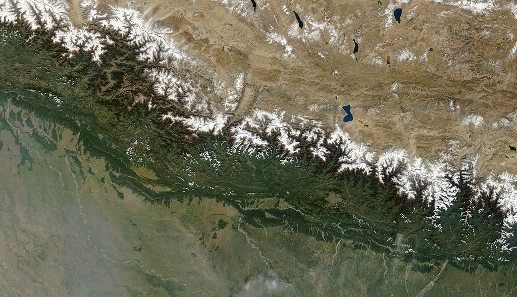 A high-resolution satellite imagery map showing the dramatic topographical relief of Nepal, from the low Terai plains to the high Himalayan mountain range.