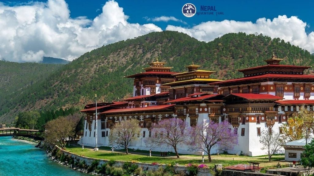 Bhutan vs Nepal Tourism - Majestic architecture of a traditional Bhutanese dzong fortress nestled in the Himalayan mountains, showcasing Bhutan's serene culture.