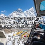 View from inside a helicopter cockpit during an Everest Base Camp Helicopter Tour, looking out at Mount Everest, snow-capped Himalayan peaks, and yellow expedition tents on the Khumbu Glacier below.