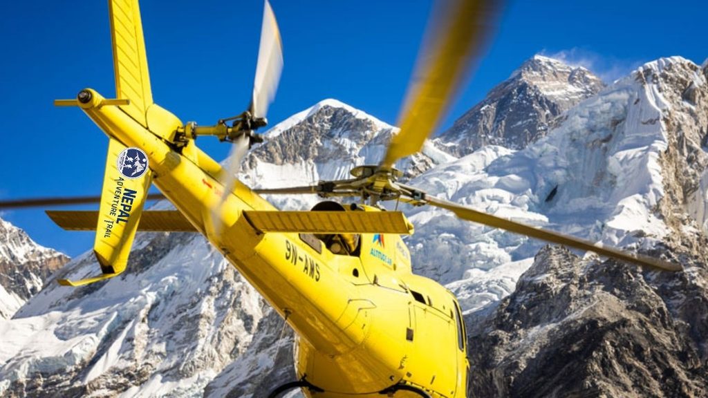 A yellow sightseeing helicopter landing near hikers and colorful expedition tents at Everest Base Camp against the dramatic backdrop of Mount Everest and high-altitude Himalayan peaks during an Everest Base Camp Helicopter Tour.