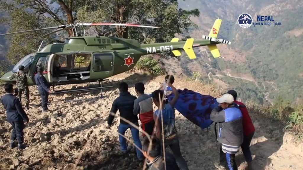 An army air ambulance helicopter operating in high-altitude terrain, representing emergency Heli Ambulance Nepal medical evacuation capabilities. A military chopper painted in olive drab with a red cross emblem banks against rugged mountain slopes.