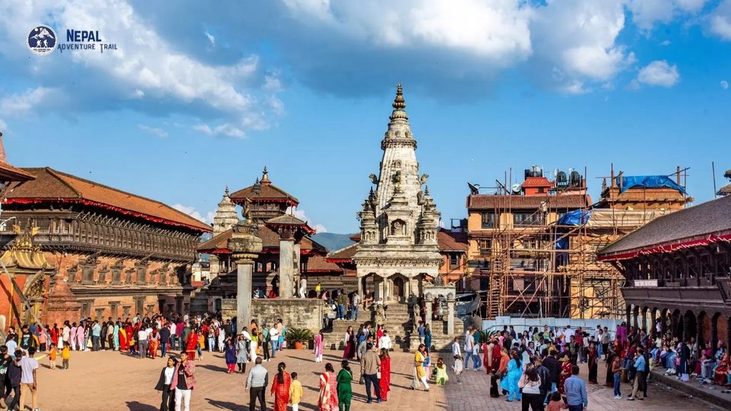 Bhaktapur Durbar Square - A vibrant view of the ancient royal palace complex in Nepal, featuring the towering, multi-tiered Nyatapola Temple and intricate Newari architecture under a clear blue sky.