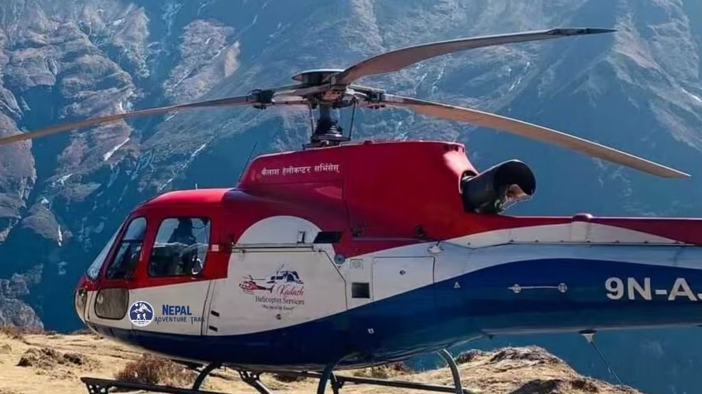 A red sightseeing helicopter parked on a high-altitude mountain helipad with Mount Everest and snow-capped Himalayan peaks in the background during a Himalayan Helicopter Tour Nepal.