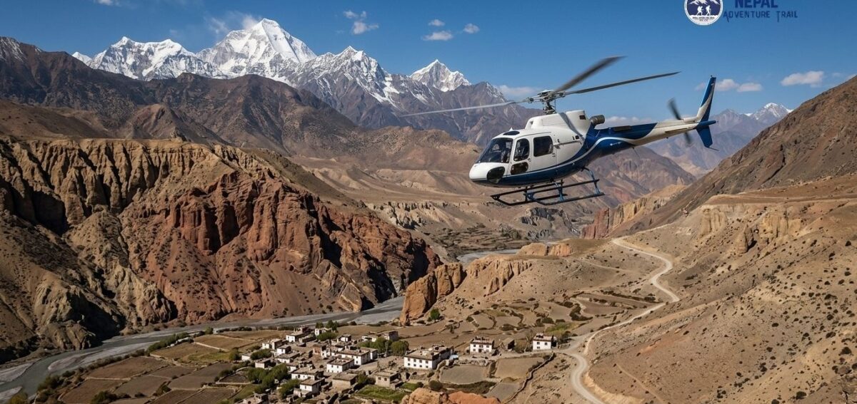 mustang helicopter nepal Aerial view from a Mustang Helicopter Tour Nepal flying over the arid, red rock canyons and traditional villages of Upper Mustang with the snow-capped Himalayan peaks in the background.